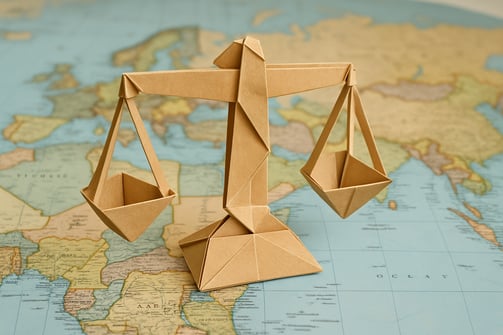 origami balance scale sitting on a map of the world-1