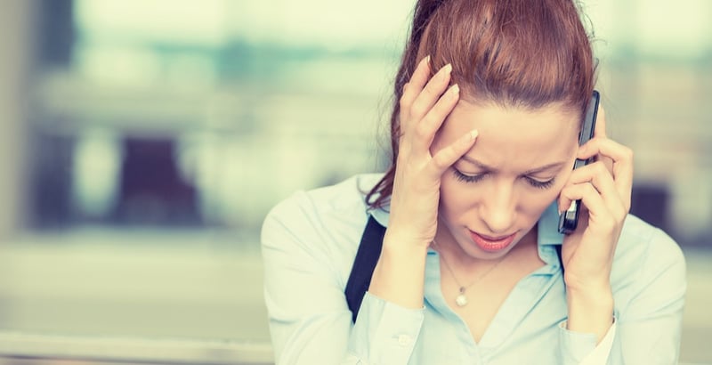 Portrait unhappy young woman talking on mobile phone looking down- Human face expression, emotion, bad news reaction